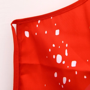 Detailed macro view of the festive red fabric with white dots and neat stitched edging