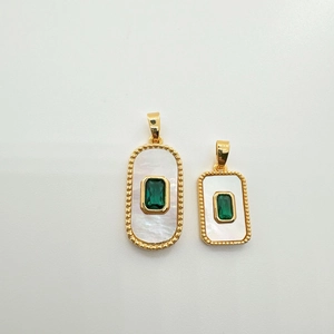 Detail of gold-plated rectangle pendant with white shell and green gemstone inlay