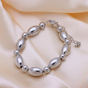 Detail of silver beaded bracelet with polished olive beads and adjustable lobster clasp