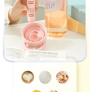 Detail of pink tea infuser bottle showing water scale, filter and leakproof seal