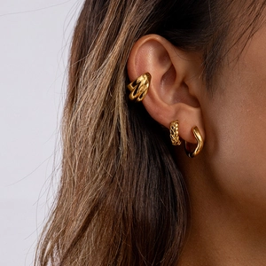 Classic 18K gold plated stainless steel wave earrings and ear cuffs on a model