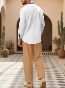 Men's white linen blend Henley shirt and khaki trousers on casual vacation setting