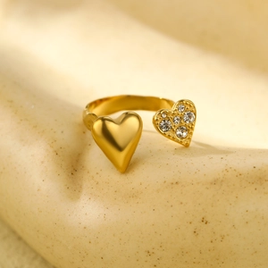 Detailed macro shot of golden open ring featuring one polished and one crystal heart