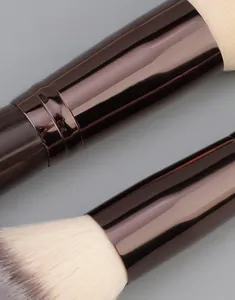 Macro detail of high-gloss brown thickened aluminum tube and soft fiber brush bristles