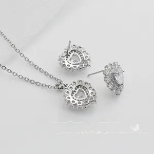 Detailed view of silver heart jewelry set with ruby red stones and micro-pave crystals