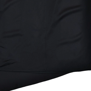 Close-up macro shot of black fabric texture and premium stitching on the t-shirt hem