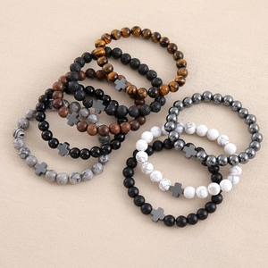 Stack of seven natural stone bead bracelets with cross charms and volcanic lava stones