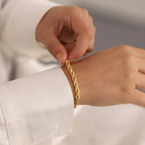 Minimalist 18K gold plated stainless steel rope chain bracelet worn on a female wrist
