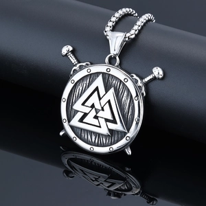 Detail of vintage silver Viking pendant with Valknut shield and crossed swords on beads chain
