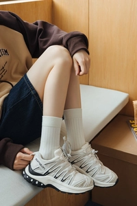 Close-up of lightweight breathable white mesh sneakers with classic hiking style design