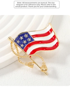 Detail of wavy American flag brooch with gold plating, enamel stripes, and clear rhinestones