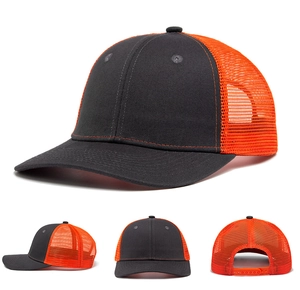 Detail of dark grey and orange mesh trucker hat showing adjustable snapback and stitching