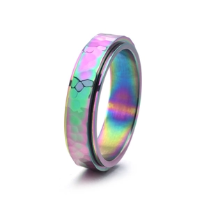 Close-up of rainbow iridescent spinner ring with handmade hammered metal texture
