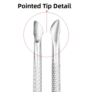 Detailed macro view of sharp stainless steel cuticle pusher tip for professional manicure