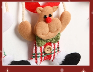 Close-up of reindeer plush ornament with red antlers and knitted striped body detail