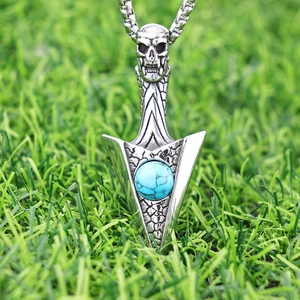Detailed view of punk skull arrow pendant with blue turquoise stone and stainless steel chain