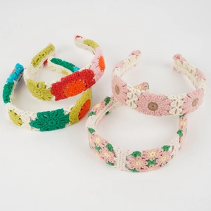 Detailed macro view of handmade crochet floral headbands in vibrant and pastel colors