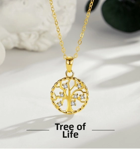 Macro view of gold Tree of Life pendant with white zircon stones and fine chain