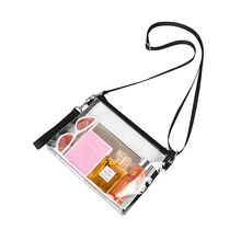 Macro shot of transparent PVC crossbody bag showing internal storage capacity and black zipper