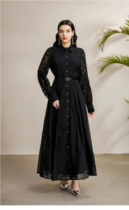 Detailed view of long sleeve lace embroidery and metal buttons on a vintage black dress