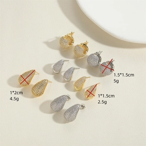 Elegant gold and silver pavé zircon earrings in pear and round shapes on beige background