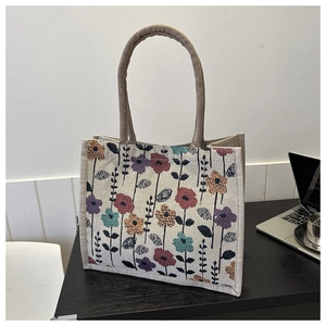 Detailed macro view of woven tote bag featuring vintage floral patterns and rope handles