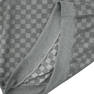 Macro shot of grey checkerboard knit fabric and ribbed cuff texture on men sweater