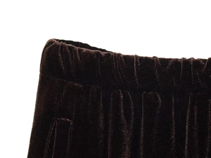 Detail of elastic waistband on dark velvet trousers with high-quality stitching