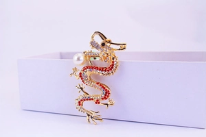 Detailed close-up of a dragon keychain with colorful rhinestones and white pearl accent