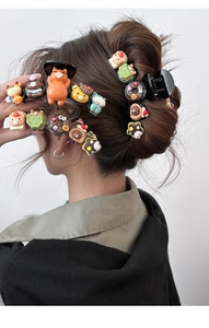 Detailed view of cute resin animal and donut hair clips styled on a bun hairstyle