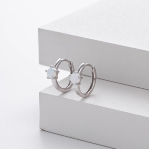 Close-up of minimalist S925 sterling silver hoop earrings with round white opal stone
