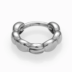 Detailed close-up of a silver twisted huggie hoop earring with a polished mirror finish