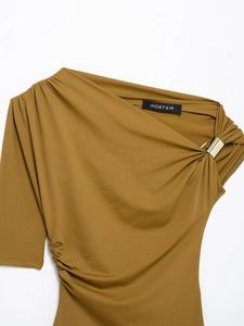 Close-up of ginger yellow one-shoulder top with a gold metal ring detail on the side