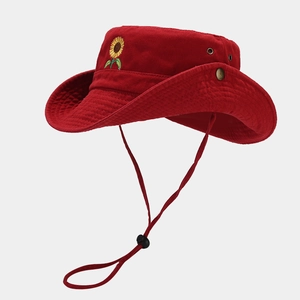 Detail of red cotton sun hat featuring sunflower embroidery and adjustable windproof strap