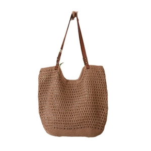 Brown hollow crochet tote bag with faux leather shoulder straps for beach vacation style