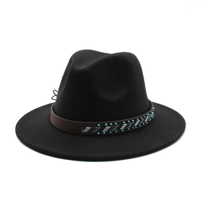 Close-up of black wool fedora with brown leather band and intricate beaded details