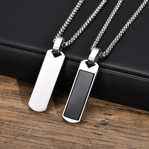 Detail of silver rectangle pendant with black agate inlay on polished stainless steel chain