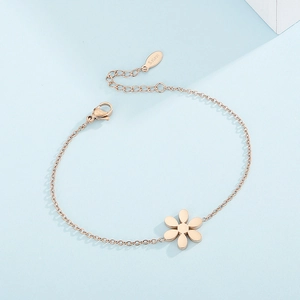 Close-up of rose gold stainless steel bracelet featuring petal charms and lobster clasp