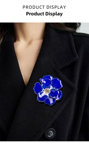 Detailed view of blue enamel rose brooch with rhinestones on a black coat lapel