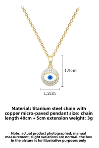 Macro detail of gold evil eye necklace with crystals, titanium steel chain and dimensions