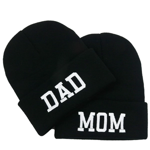 Matching MOM and DAD white embroidery black knit beanies for couples on white background