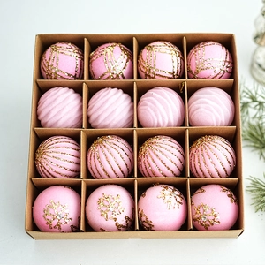 Detail of 16-pack pink flocked Christmas balls with gold glitter patterns in a gift box