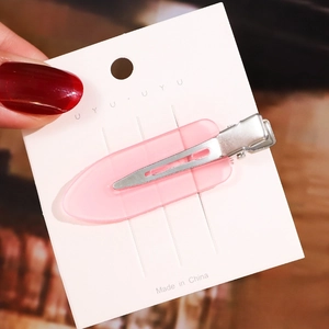 Detailed view of a 6cm pink acetate hair clip showing the smooth acrylic finish and metal base