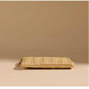 Side view of retro straw woven coin purse showing detailed breathable texture on beige background
