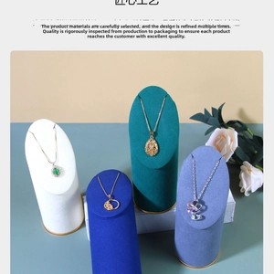 Detailed display of assorted luxury necklace pendants on tiered velvet jewelry stands