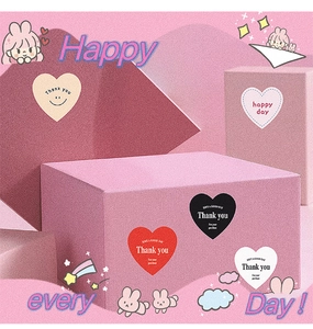 Close-up of heart-shaped Thank You stickers on gift boxes and envelopes for decoration