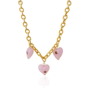 Detail of gold chunky chain necklace featuring three pink heart pendants on white background