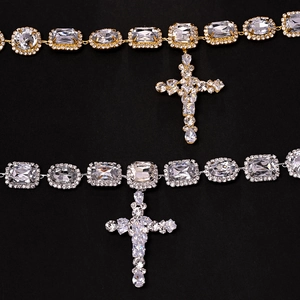 Detail of cross pendant necklace with large clear crystals in gold and silver finish
