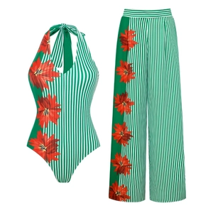 Detailed view of green striped halter swimwear with tropical red flower print