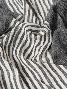 Close-up of pinstripe cotton-linen blend fabric with natural wrinkled texture